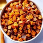 Delicious roasted sweet potatoes seasoned and golden brown on a serving plate