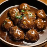 Slow Cooker Salisbury Steak Meatballs served with gravy and mashed potatoes
