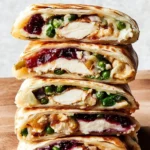 Thanksgiving Crunchwrap filled with turkey, stuffing, and cranberry sauce