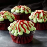 Zombie Brain Cupcakes decorated with edible brains and spooky frosting