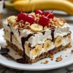 Delicious Banana Split Dump Cake topped with whipped cream and cherry