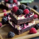 Delicious blackberry cheesecake brownies topped with fresh blackberries