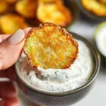 Crispy air fryer zucchini chips on a plate, a healthy snack alternative.
