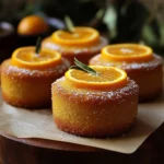 Sliced Orange Ginger Honey Cake topped with orange slices and ginger